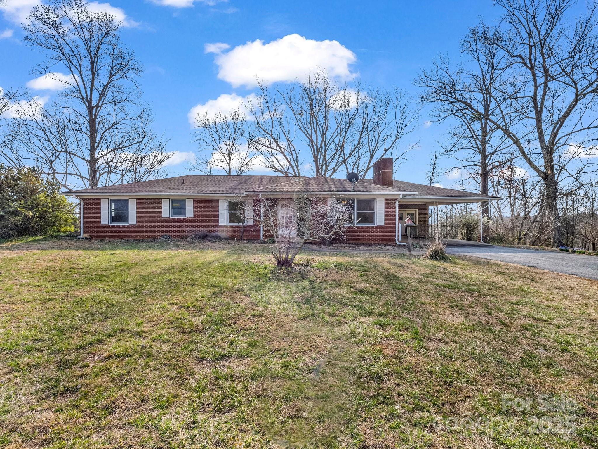 6 Rachel Bell Road Mill Spring, NC 28756 - Photo 5 of 39 a view of a house with a yard and a tree