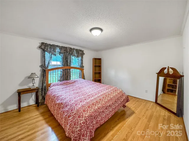 a bedroom with a bed and a large window
