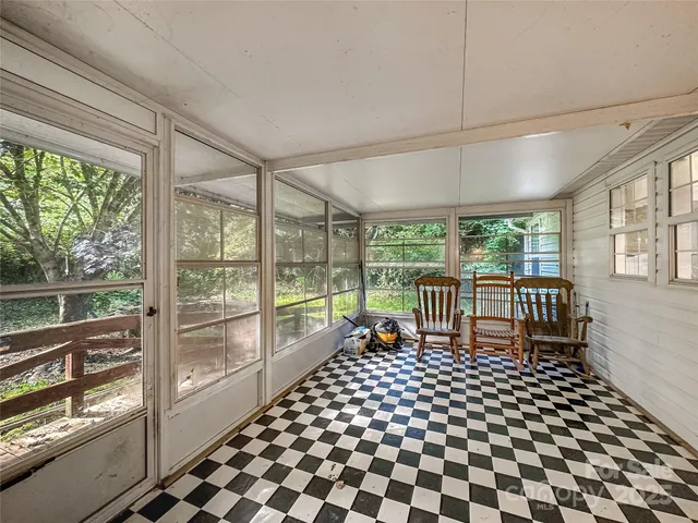 a bedroom with furniture and large window