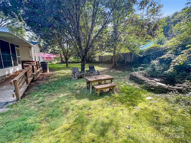 a swimming pool with outdoor seating and yard