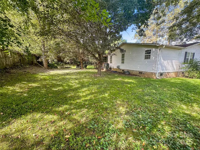a view of a backyard with large trees