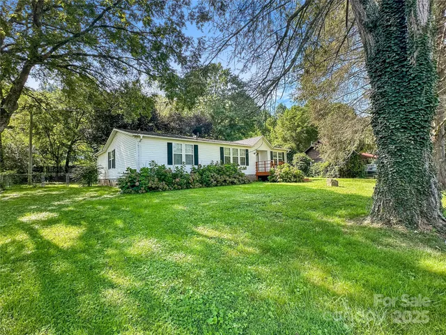 a view of house with backyard space and garden