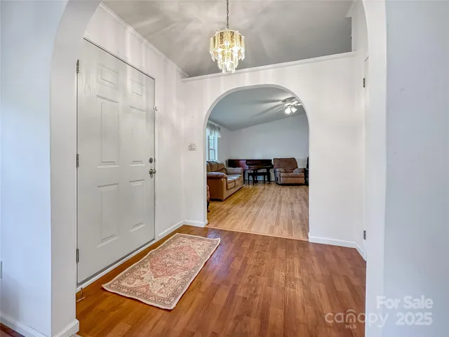 a view of a hallway view with wooden floor and furniture