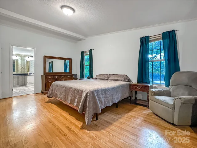 a bedroom with a bed couch and window