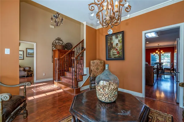 a living room with furniture and a chandelier