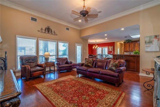 a living room with furniture a rug and a chandelier