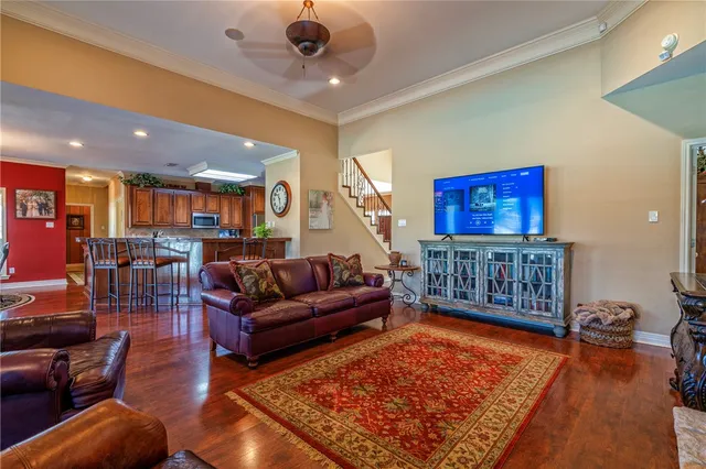 a living room with furniture ceiling fan and a rug