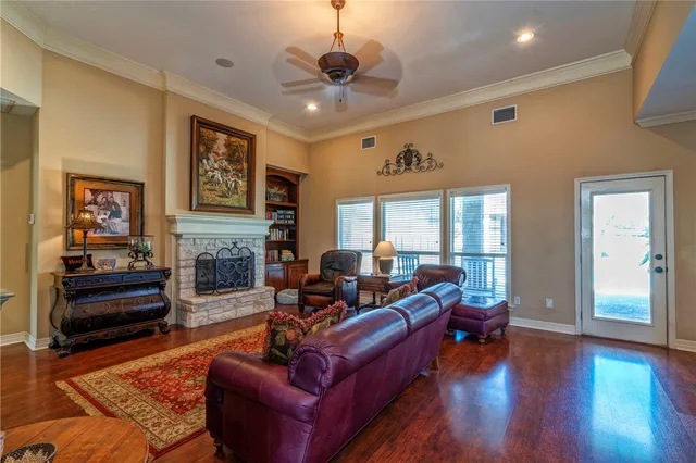 a living room with fireplace furniture and a wooden floor