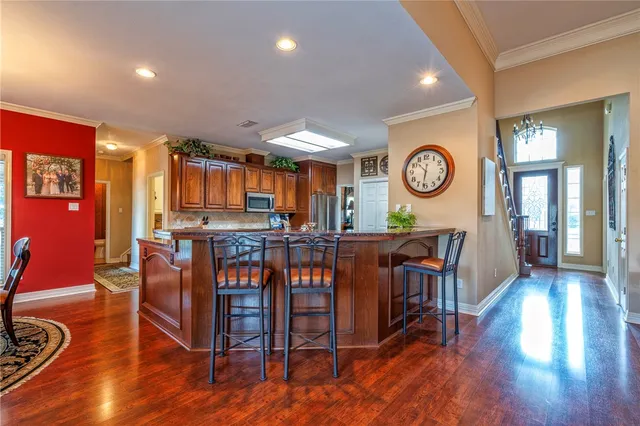 a living room with furniture a wooden floor and a clock