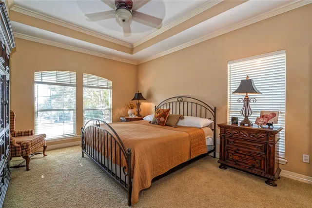 a bedroom with a bed window and a ceiling fan