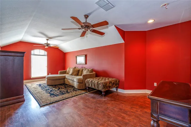 a living room with furniture rug and wooden floor