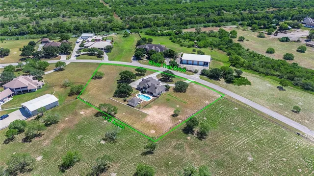 an aerial view of residential houses with outdoor space