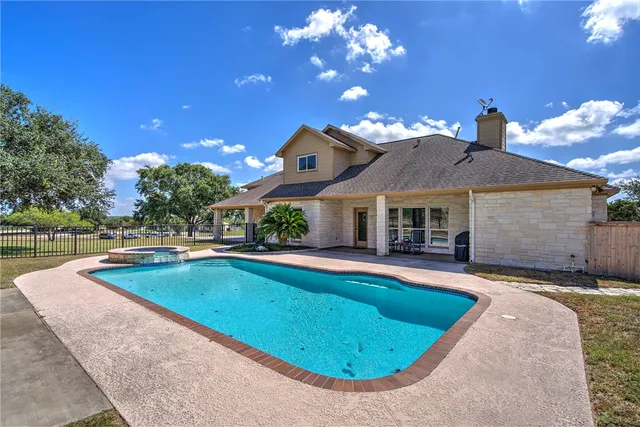 a front view of house with yard swimming pool and outdoor seating