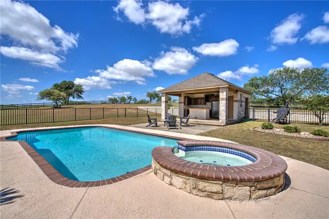 a view of a swimming pool with lounge chair