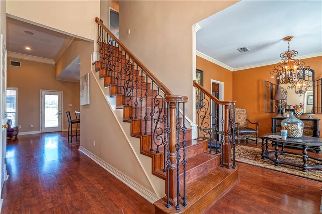 a view of entryway and hall with wooden floor