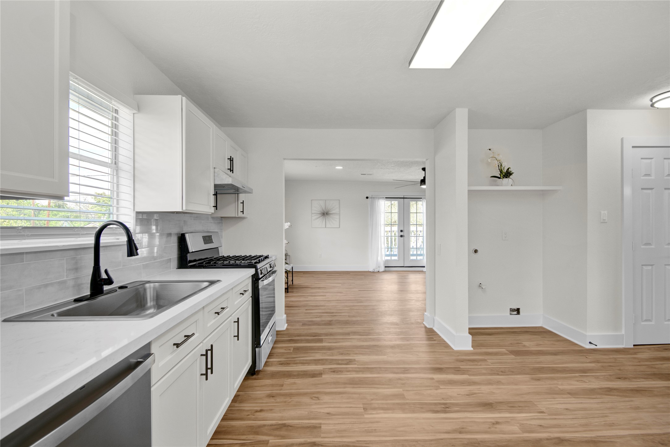 4909 Cochran Street, Unit 12 Houston, TX 77009 - Photo 11 of 29 a kitchen with granite countertop a sink stove and cabinets