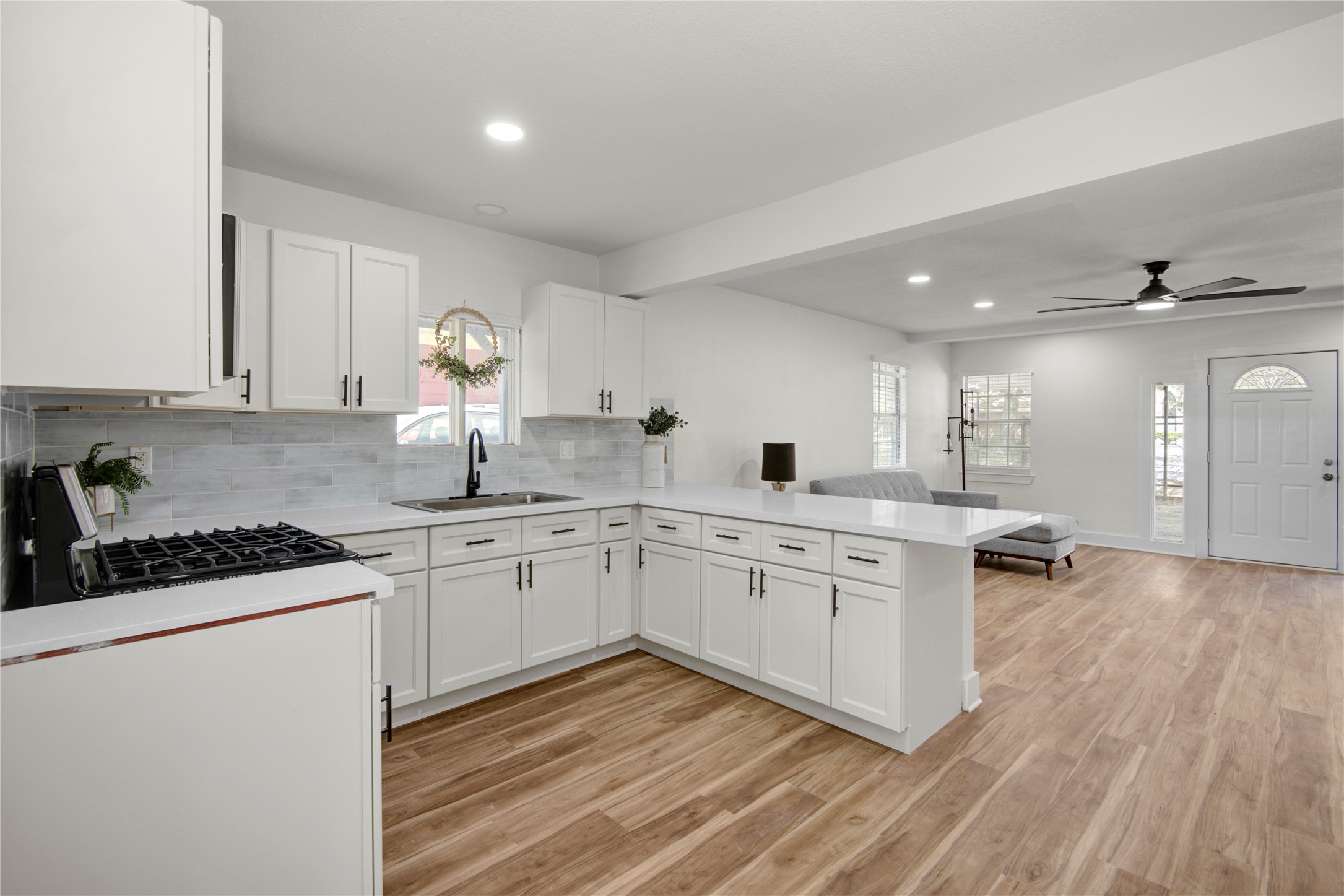 4909 Cochran Street, Unit 12 Houston, TX 77009 - Photo 2 of 29 a kitchen with granite countertop white cabinets and white appliances