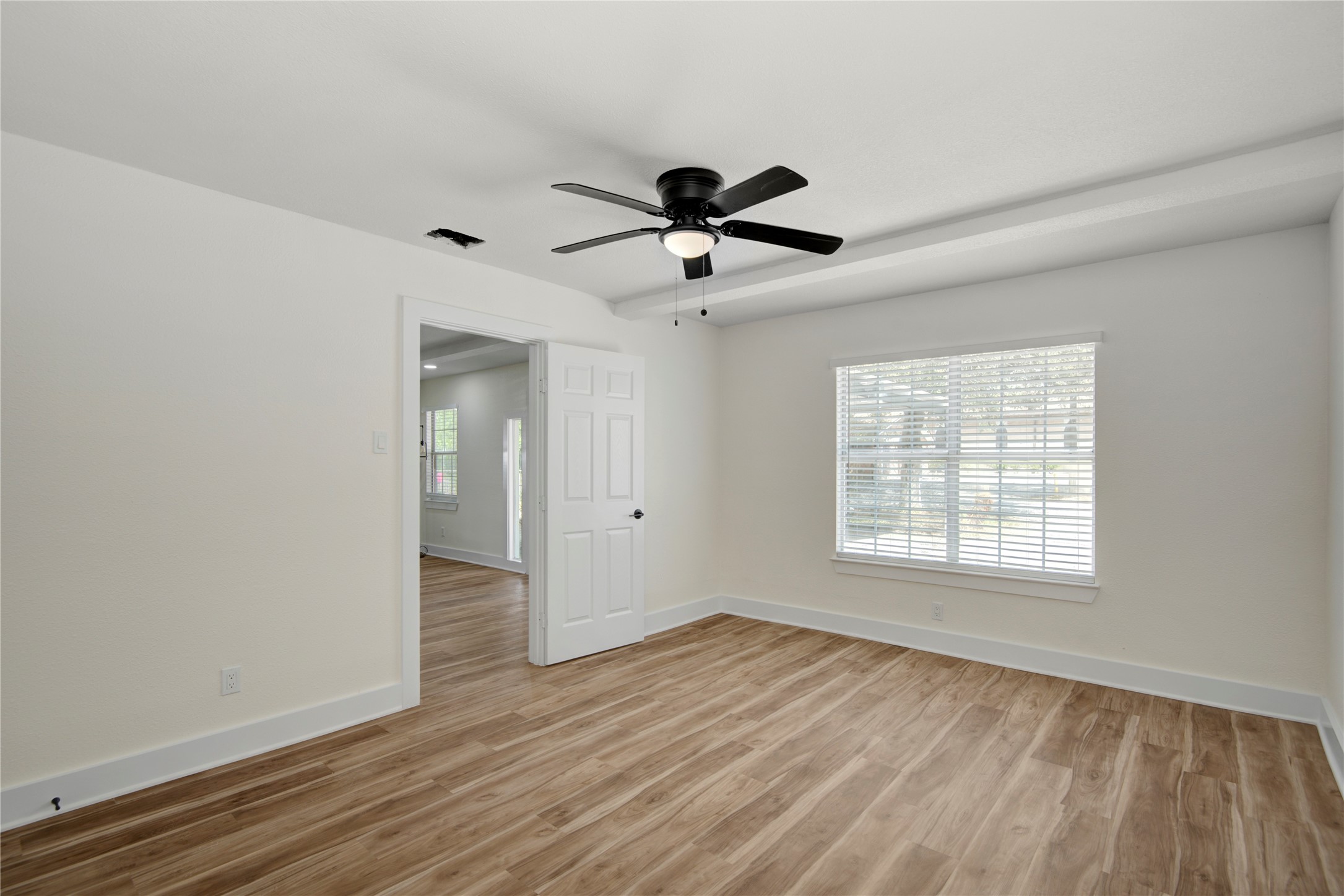 4909 Cochran Street, Unit 12 Houston, TX 77009 - Photo 6 of 29 a view of empty room with wooden floor and fan