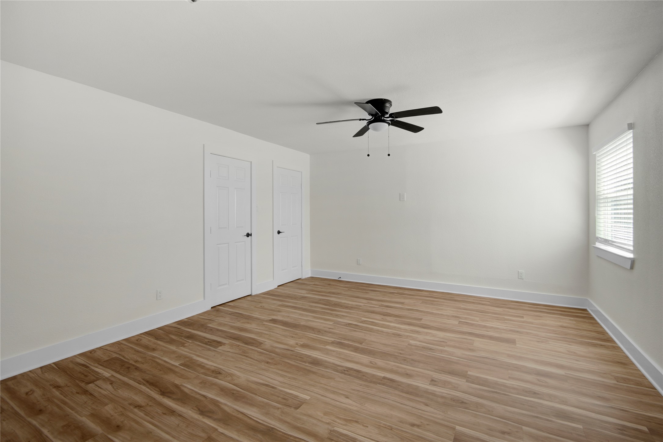 4909 Cochran Street, Unit 12 Houston, TX 77009 - Photo 7 of 29 a view of empty room with wooden floor and fan