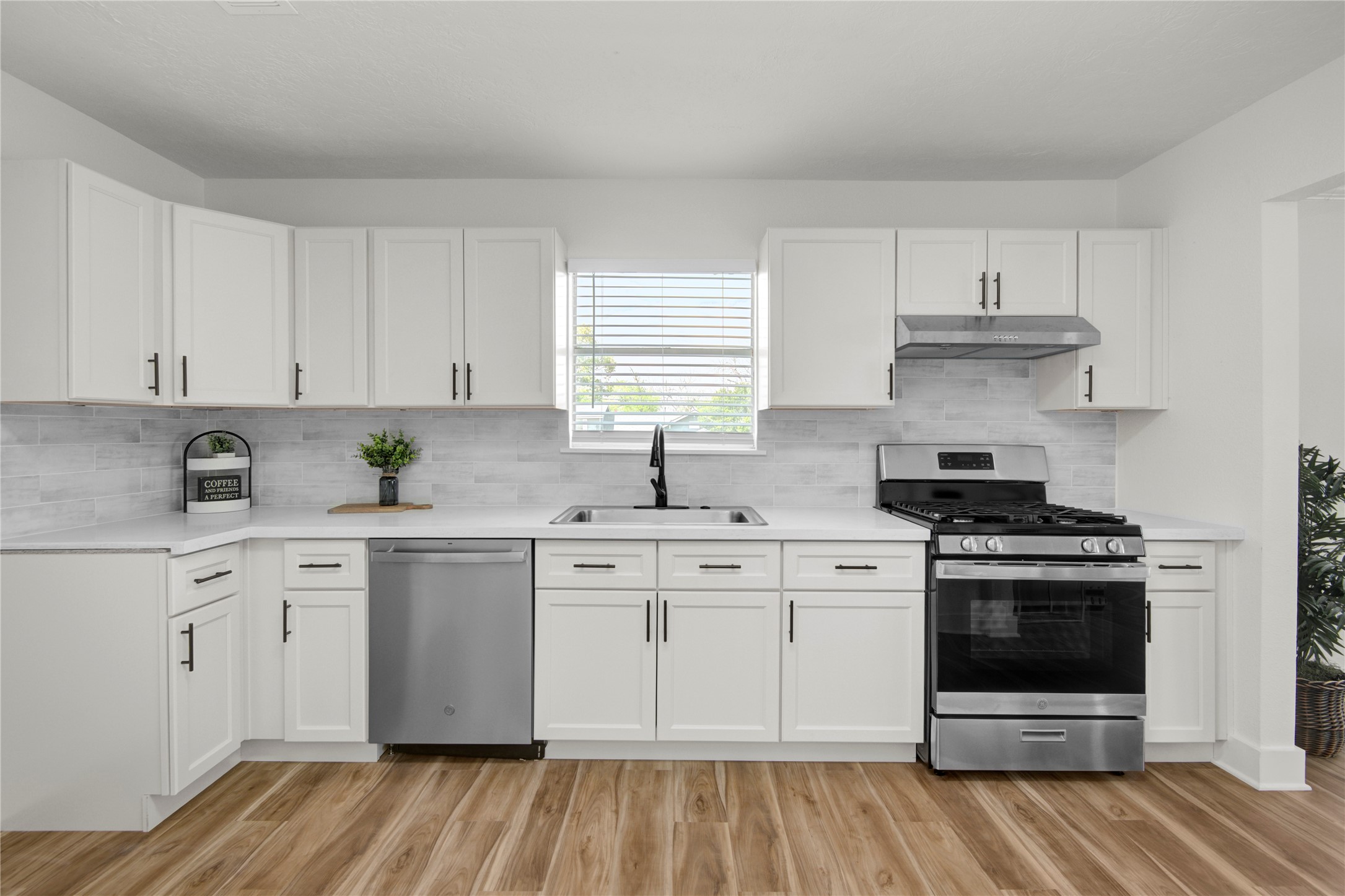 4909 Cochran Street, Unit 12 Houston, TX 77009 - Photo 9 of 29 a kitchen with stainless steel appliances granite countertop a stove and white cabinets