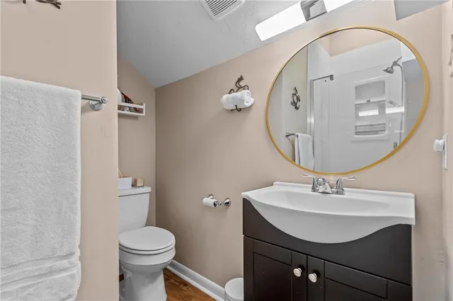 a bathroom with a sink mirror and toilet