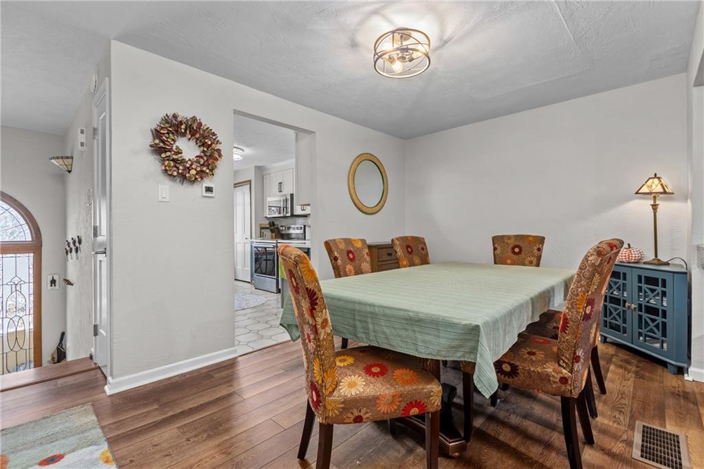 1104 West Ridge Road Allison Park, PA 15101 - Photo 6 of 32 a view of a dining room with furniture and wooden floor