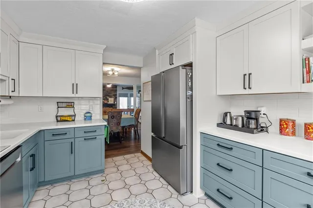 a kitchen with stainless steel appliances a refrigerator sink and cabinets