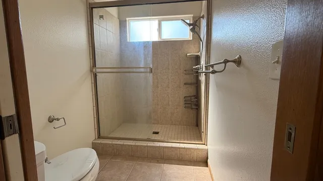 a bathroom with a toilet and shower