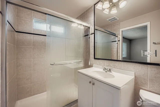 a bathroom with a sink a mirror and a shower