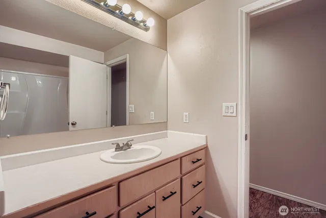 a bathroom with a sink double vanity and a mirror