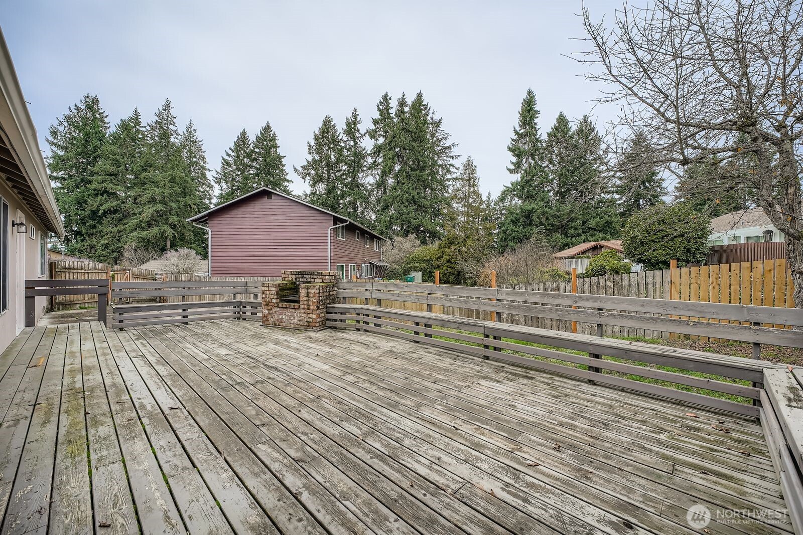 2738 Southwest 323rd Street Federal Way, WA 98023 - Photo 23 of 26 a view of house with deck outdoor seating and trees in the background