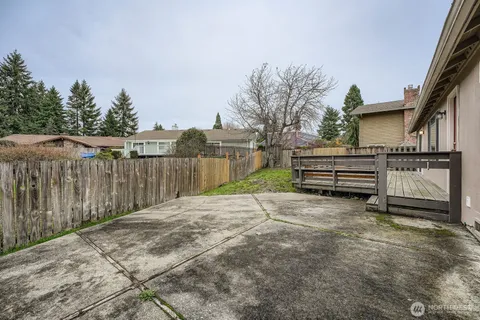a view of a house with a wooden fence