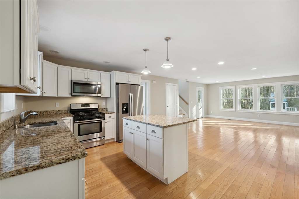 2 Pine Cone Lane East Freetown, MA 02717 - Photo 4 of 38 a large kitchen with granite countertop a stove top oven a sink a counter space and cabinets