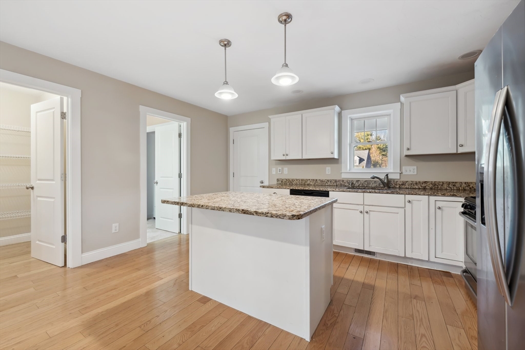 2 Pine Cone Lane East Freetown, MA 02717 - Photo 6 of 38 a kitchen with granite countertop white cabinets and white appliances