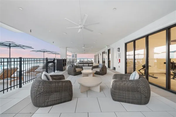 a living room with furniture and a floor to ceiling window
