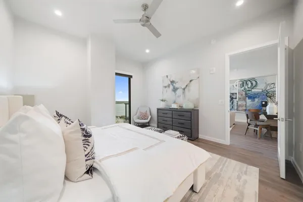 a spacious bedroom with a bed and dresser