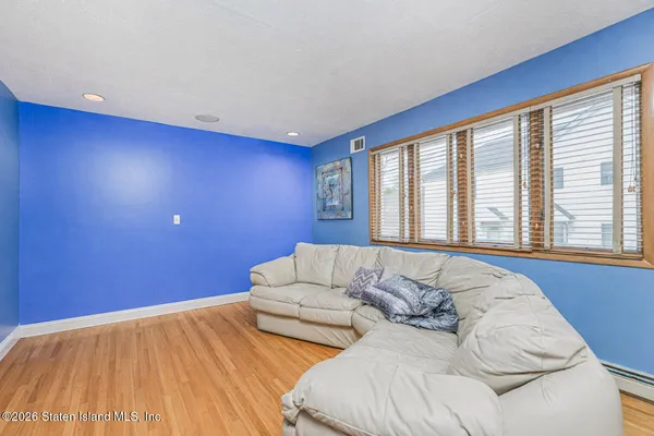 a bed sitting in a bedroom next to a blue wall