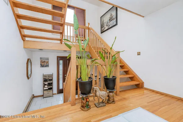 a view of entryway and hall with wooden floor