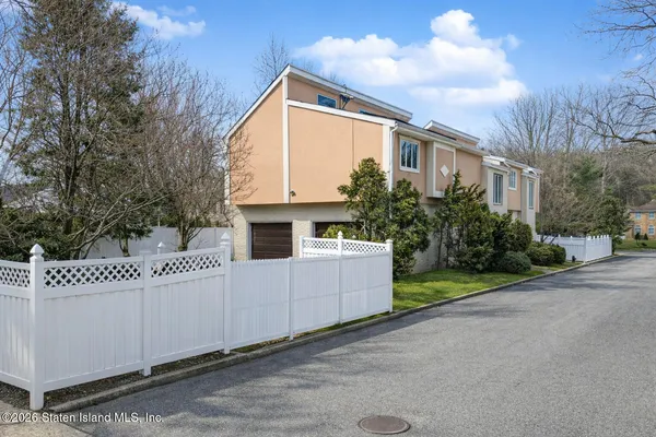 a view of a house with a yard and pathway
