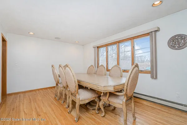 a view of a dining room with furniture window and wooden floor