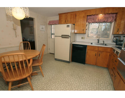 86 Noanett Road Needham, MA 02494 - Photo 5 of 9 a kitchen with stainless steel appliances kitchen island granite countertop a refrigerator a sink a stove and white cabinets