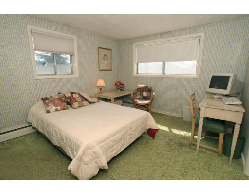 86 Noanett Road Needham, MA 02494 - Photo 8 of 9 a bedroom with a bed a table and chair