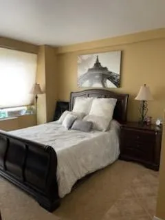 a bed sitting in a bedroom next to a window