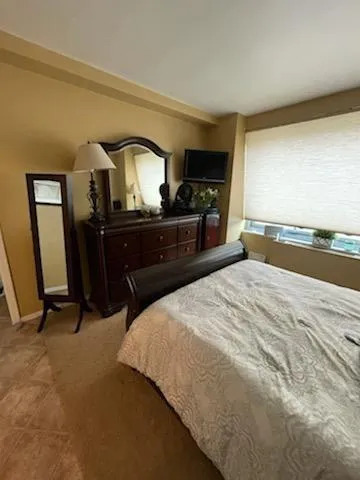 a bedroom with a bed and with furniture