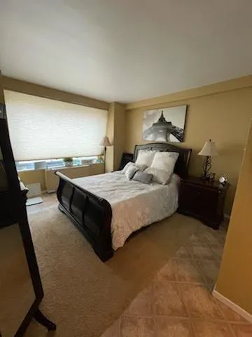 a bedroom with a bed and window