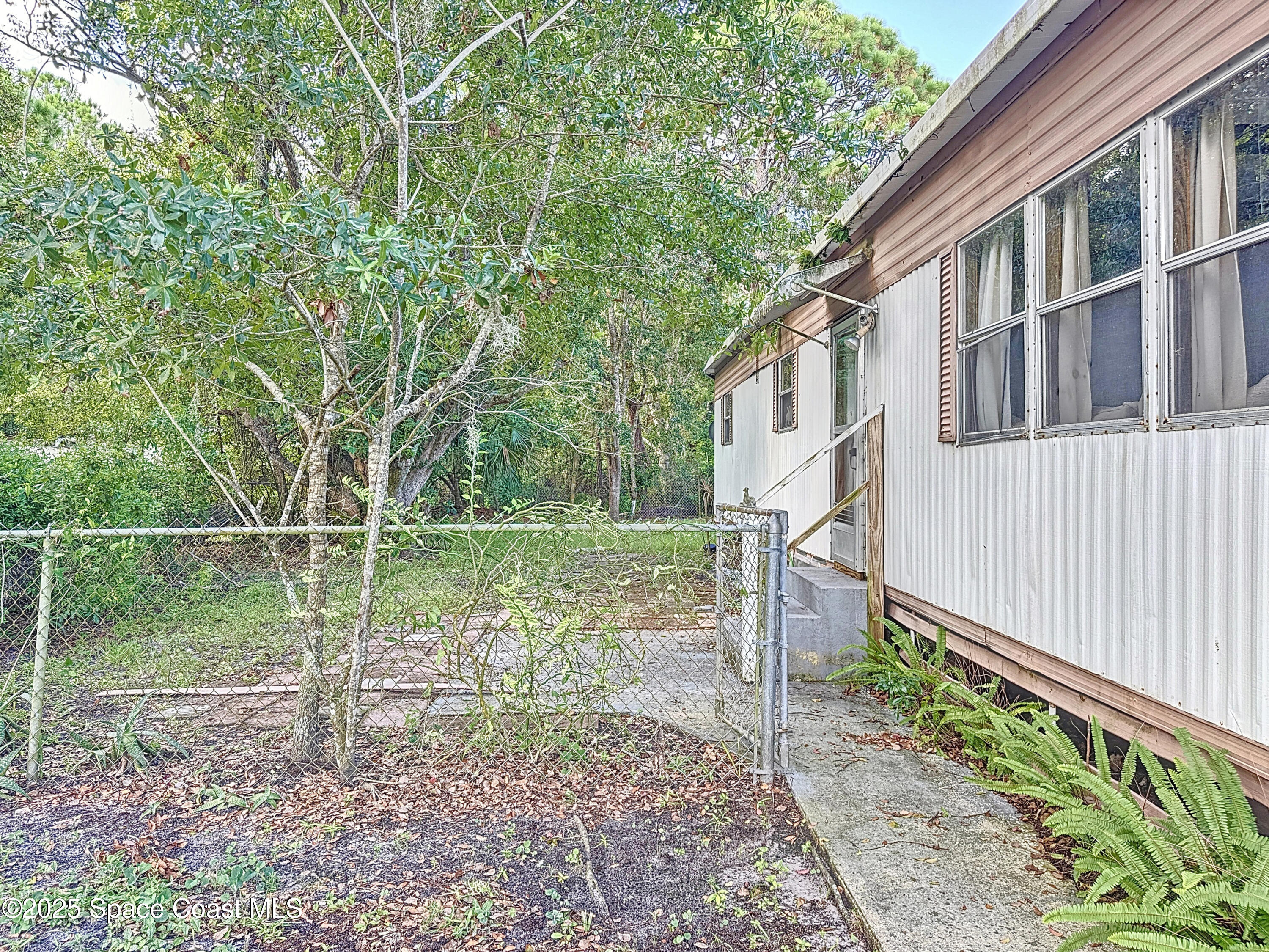 615 Baker Road Merritt Island, FL 32953 - Photo 17 of 22 a backyard of a house with lots of green space