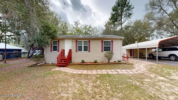 a view of a house with a yard covered in snow