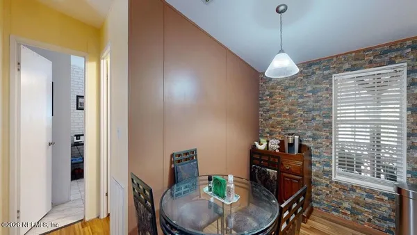 a view of a dining room with furniture window and wooden floor