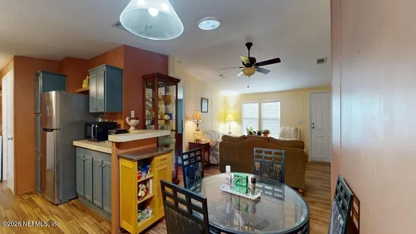a view of kitchen and dining area with chandelier