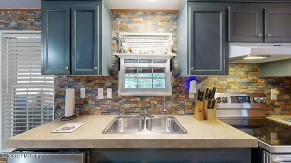 a kitchen with a sink and a window